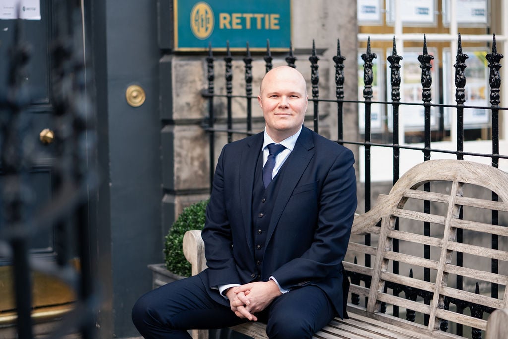 Bob Duncan sitting outside Rettie Edinburgh branch.