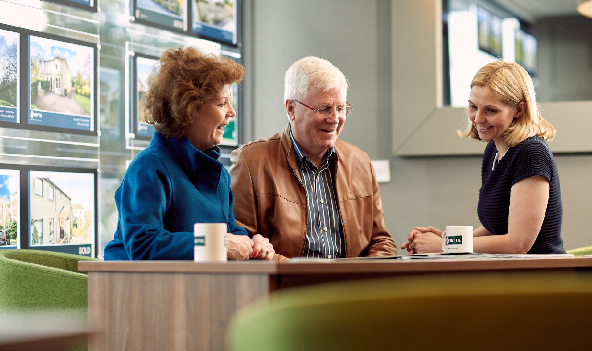 Older couple sitting at desk with member of staff in the branch