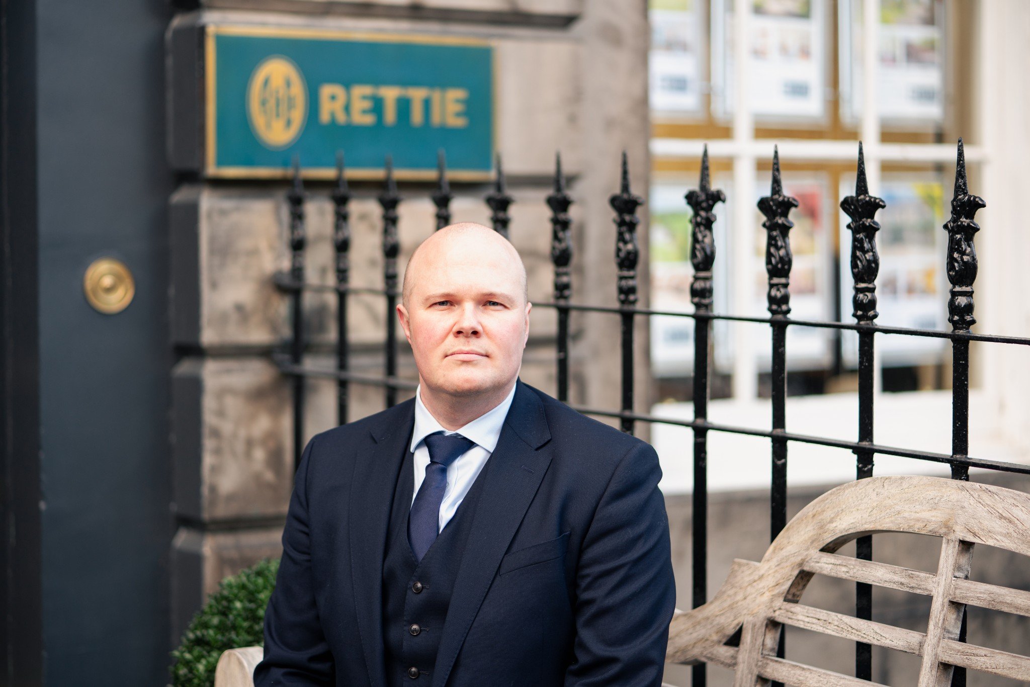 Man sitting on bench outside the Rettie office