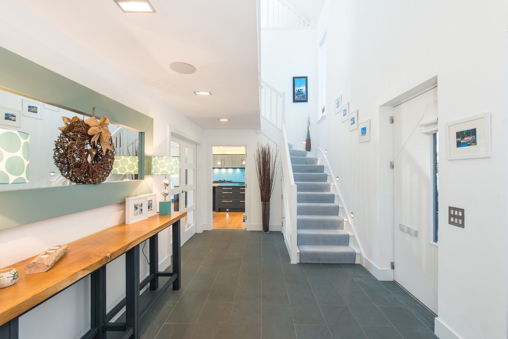 Hallway with console table and mirror and staircase