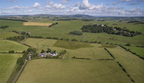 Photo of farmhouse set in the countryside