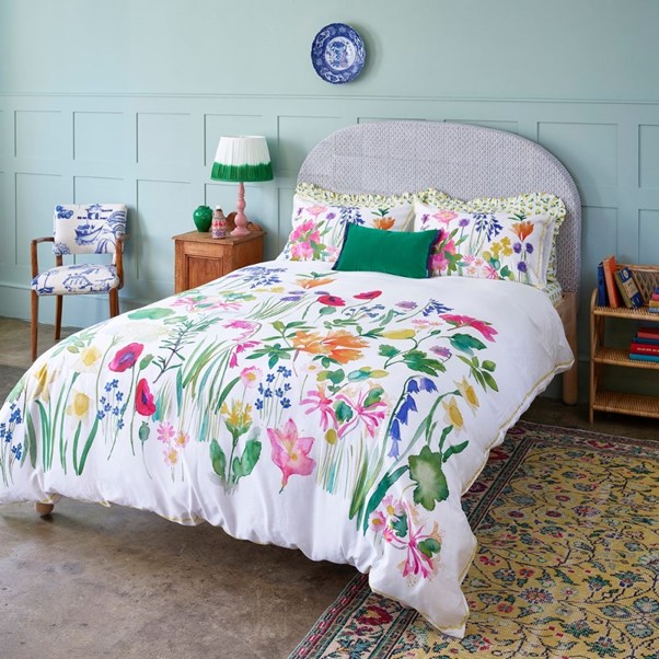 Double bed with flowers on bed linen
