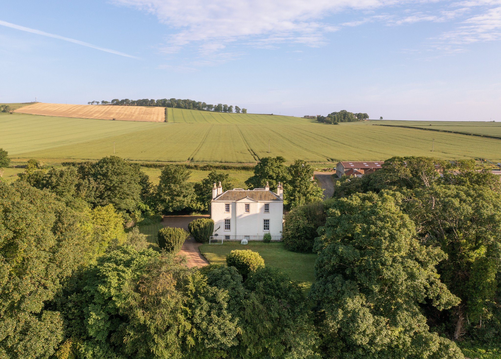 Country detached house surrounded by open fields