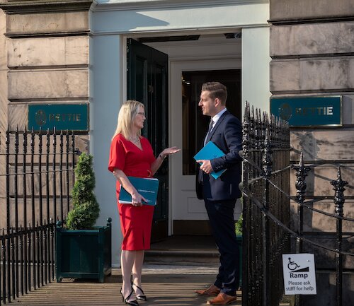 Man and woman standing on doorstep of Wemyss Place talking