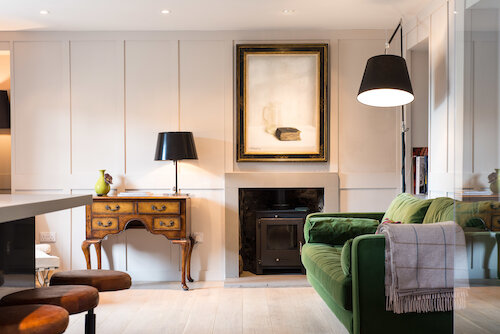 living room with green velvet sofa