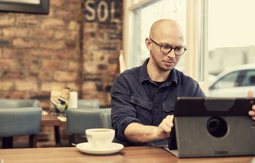 man sitting in coffee shop