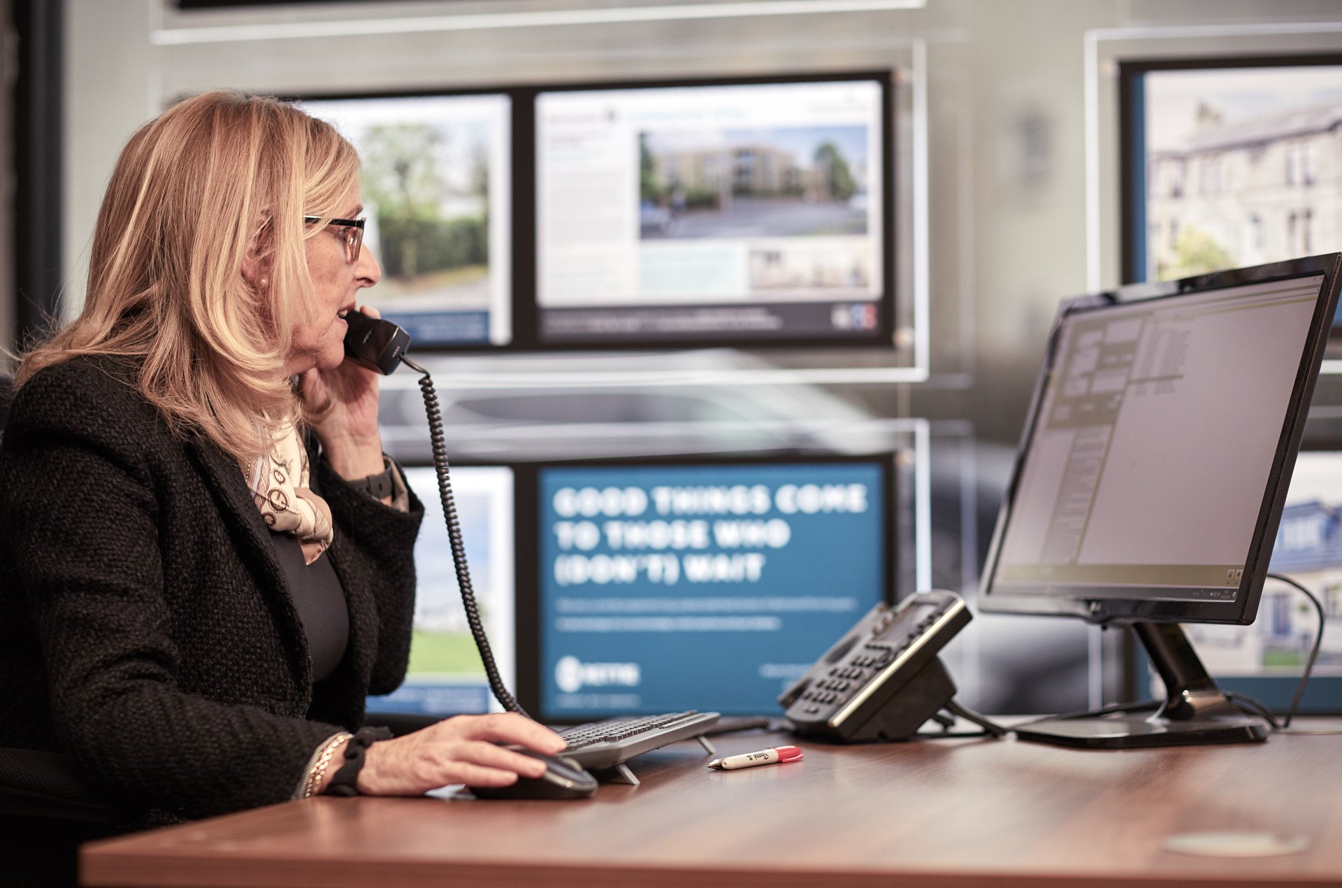 Lady working at desk and speaking on the telephone